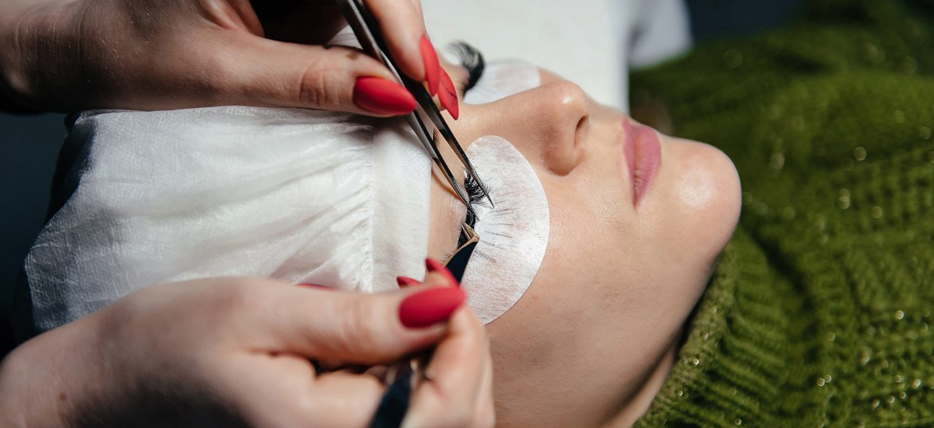 eyelash-extension-process-closeup-portrait-young-girl-woman-with-long-thick-eyelashes-eyes-closed-hand-cosmetologist-adding-more-eyelashes-her eyelash-extension-process-closeup-portrait-young-girl-woman-with-long-thick-eyelashes-eyes-closed-hand-cosmetologist-adding-more-eyelashes-her
