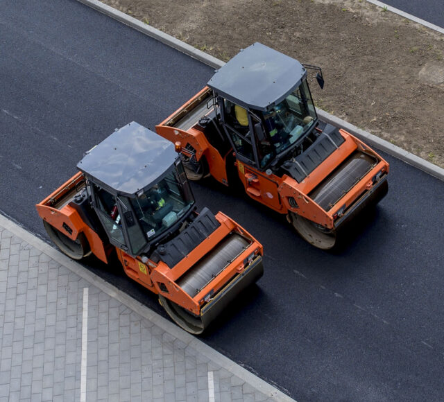 aerial-view-orange-vibratory-asphalt-roller-compactor-new-pavement (1)