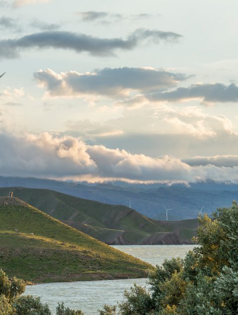 wind-power-turbine-hill-front-cloudy-sky